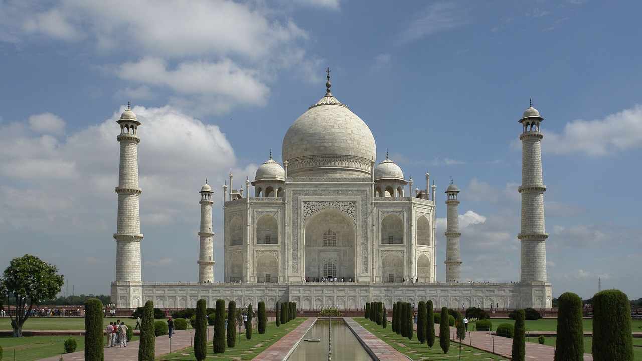 The Taj Mahal and reflecting pool at sunrise, Agra, India