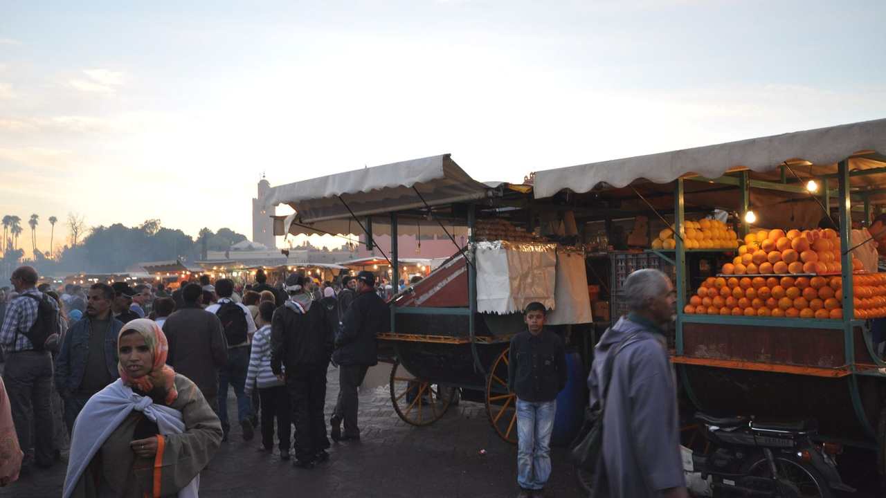 Souk stalls at Jemaa el-Fnaa square in the Marrakech medina, Morocco, packed with goods and shoppers